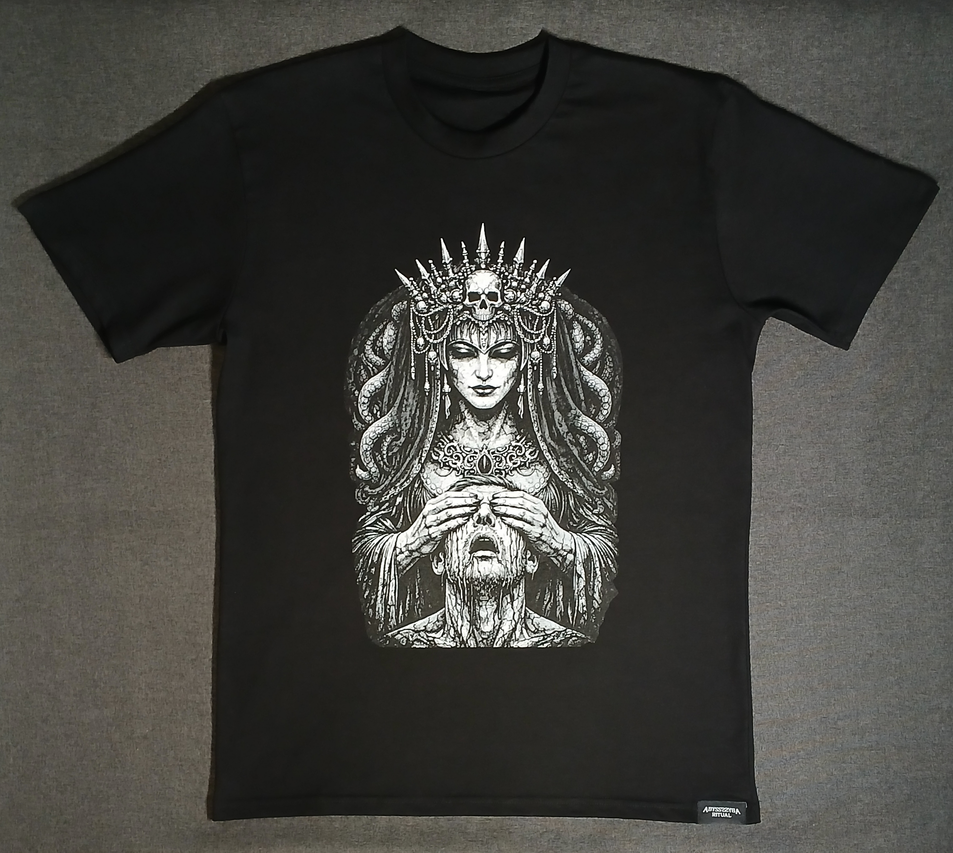 Black t-shirt with a graphic design of a woman with a skull headdress on a gray background.