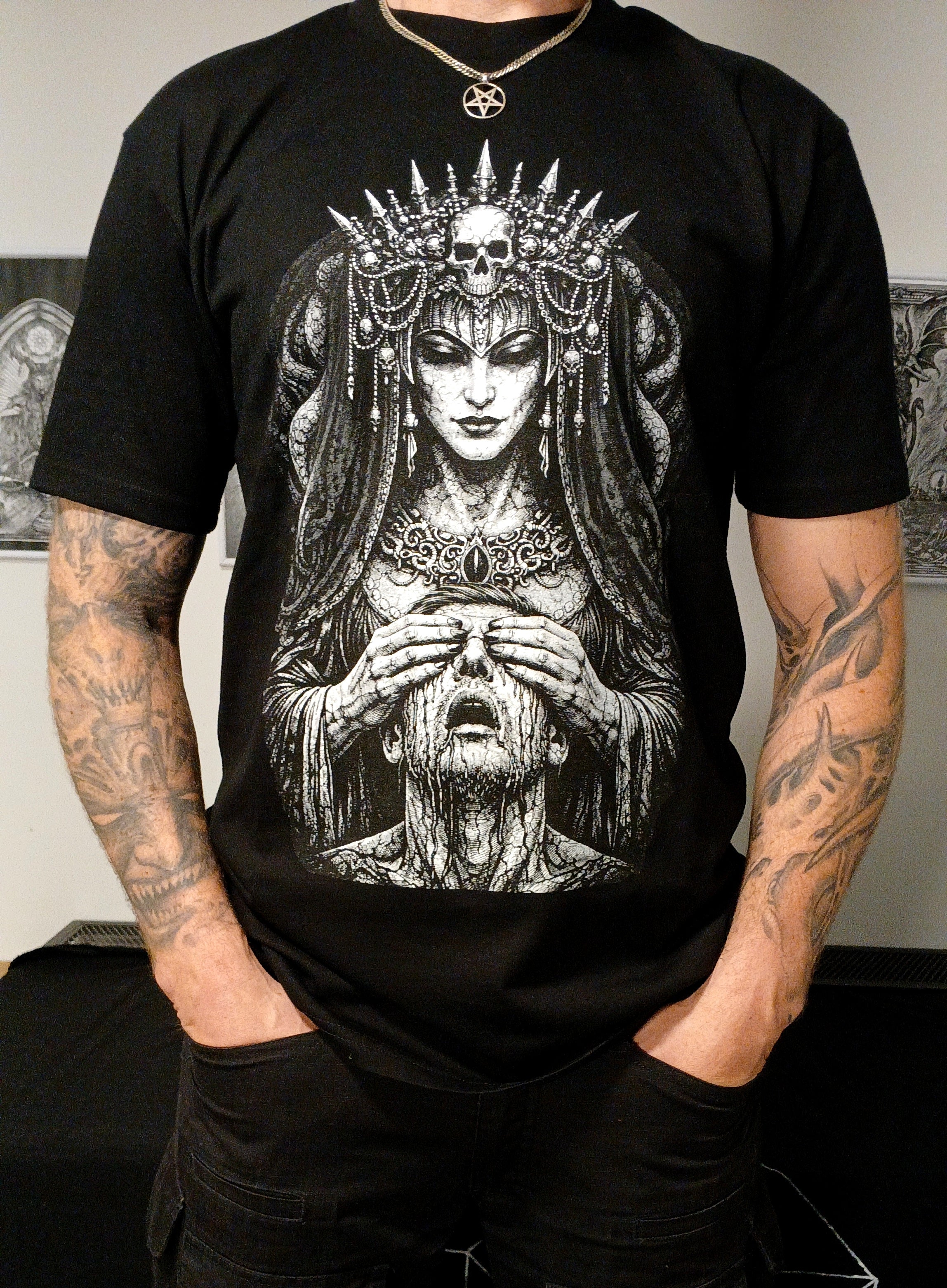 Male wearing black T-Shirt with white printed design.
