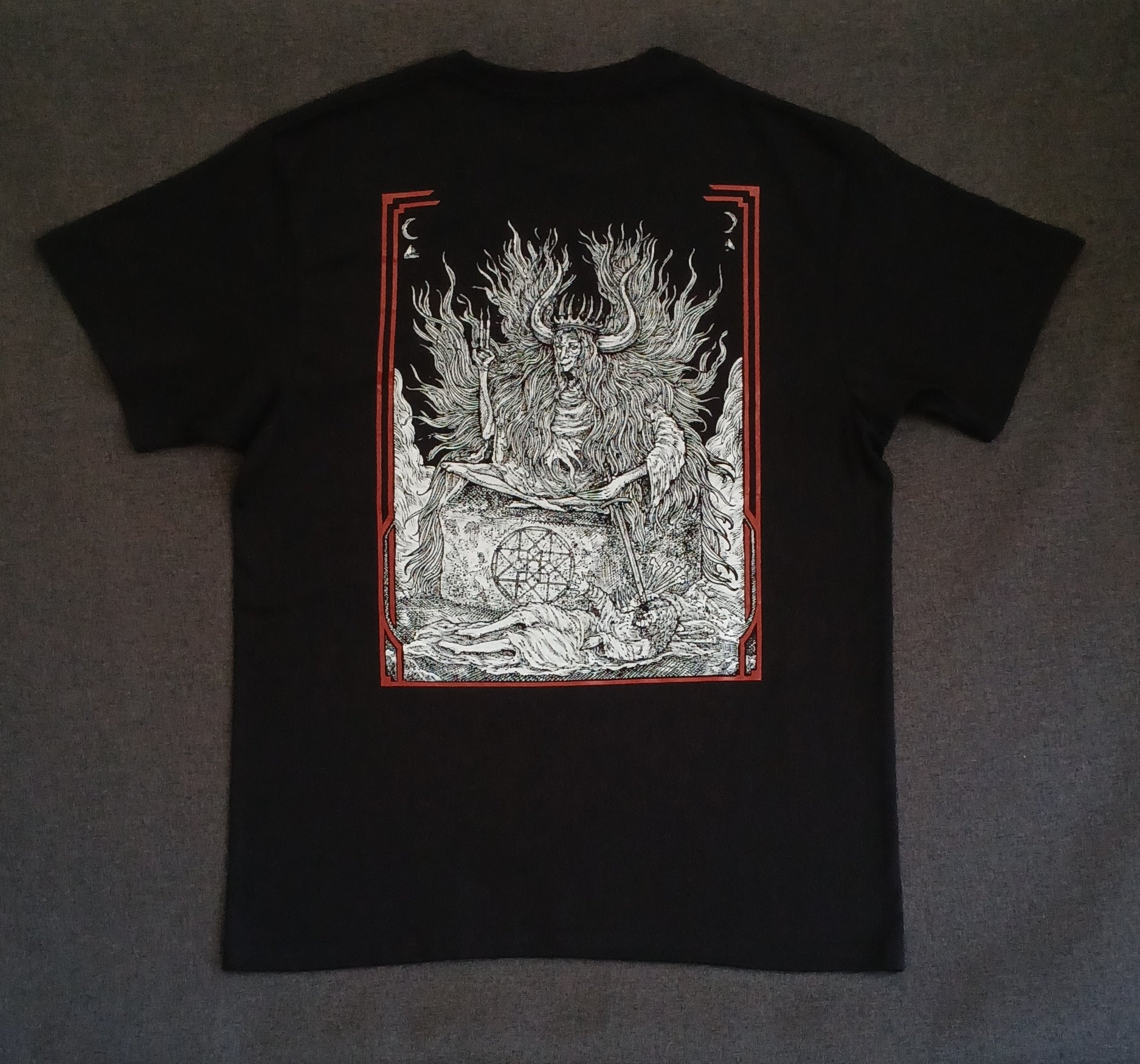 Black t-shirt with a detailed graphic design on the back against a dark background