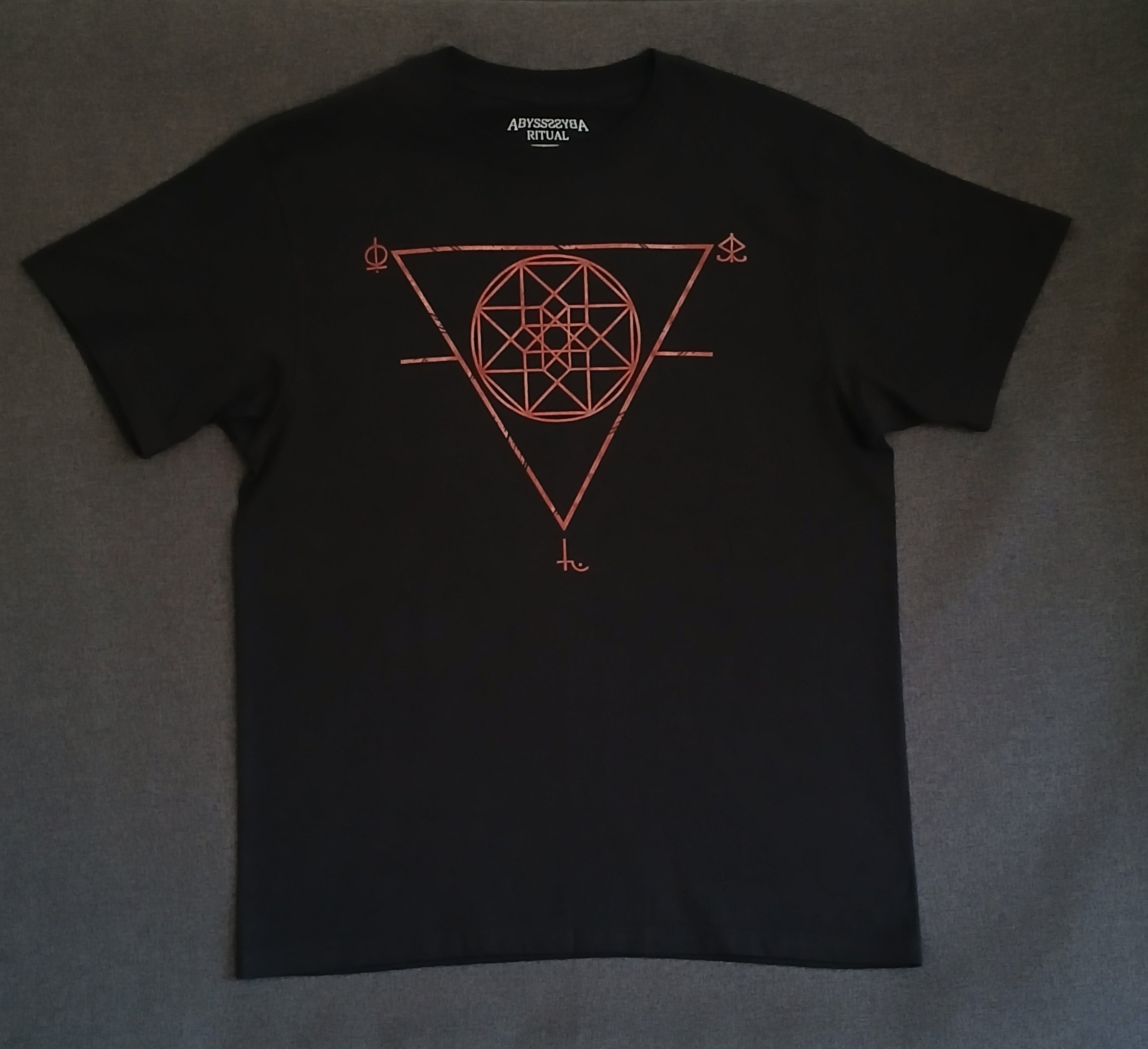 Black t-shirt with red sigil design on a gray background